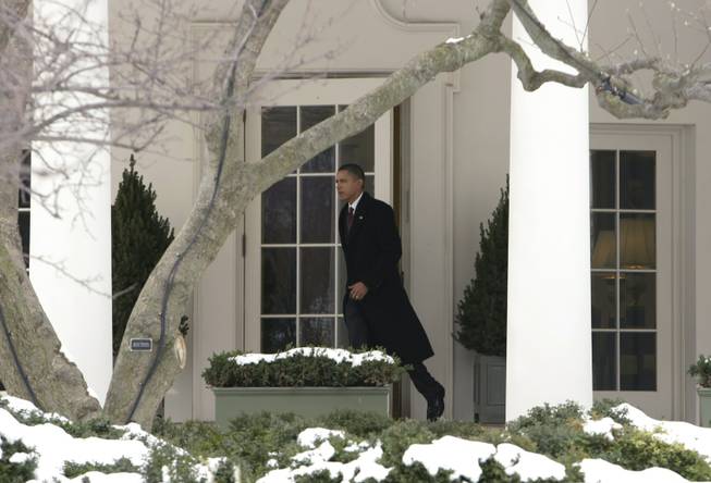 President Barack Obama leaves the White House in Washington, Tuesday, Feb. 2, 2010, for a trip to New Hampshire to push one of his State of the Union proposals: funneling $30 billion to local banks so they can lend small businesses money they need to grow their enterprises and create jobs.