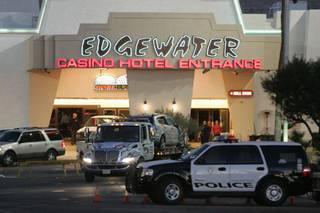 A 2007 Pontiac Vibe is towed away from the Edgewater Casino in Laughlin after a 70-year-old man drove it through the front entrance, killing two and injuring six.