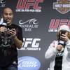 UFC light heavyweight Brandon Vera, left, and WEC featherweight Urijah Faber use their phones to take photos of the audience for their Twitter accounts before an official weigh-in for UFC 109 at the Mandalay Bay Events Center Friday, February 5, 2010.