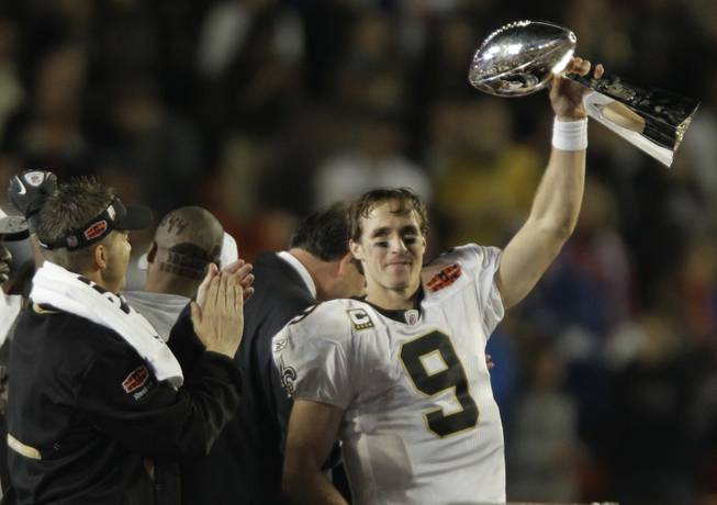 New Orleans Saints quarterback Drew Brees (9) holds the Vince Lombardi Trophy after the NFL Super Bowl XLIV football game against the Indianapolis Colts, in Miami, Sunday, Feb. 7, 2010. The Saints won 31-17. 