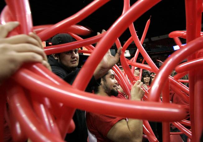 Red ballons are passed out to the student section before the start of UNLV's game against New Mexico on Wednesday, Feb. 10, 2010, at the Thomas & Mack Center.