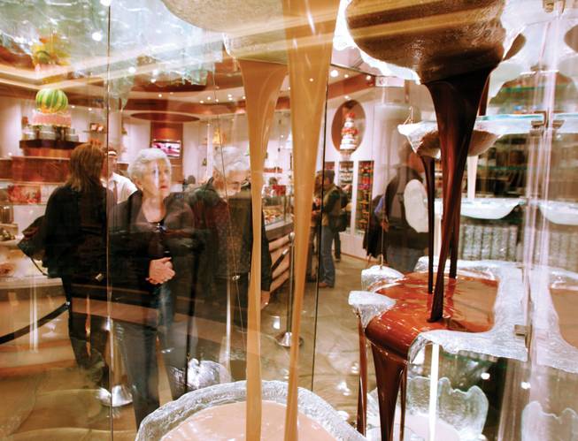 Shoppers examine the chocolate fountain at Jean-Philippe Patisserie at the Bellagio.