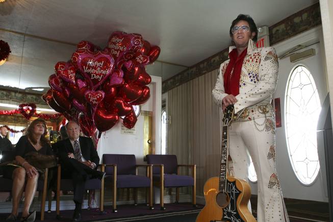 Suzanne Benefiel and David Smith, of Huntington Beach, Calif., sit in the chapel foyer with Elvis impersonator Paul Casey waiting their turn to be married on Valentine's Day 2010 at the Little White  Wedding Chapel in Las Vegas.