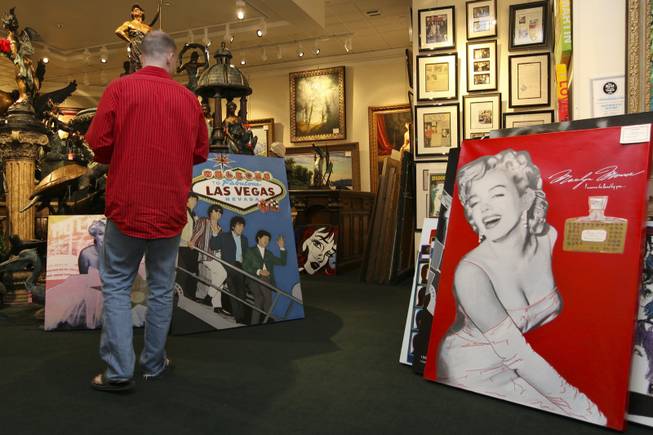 While in town for his 30th birthday, John Dirk, of Washington, D.C., stops to admire the pieces of the late pop artist Steve Kaufman on display Sunday, Feb. 14, at the Centaur Art Gallery in the Fashion Show Mall.  Kaufman, 49, of Sherman Oaks, Calif., was found dead Feb. 12 in Vail, Colo.