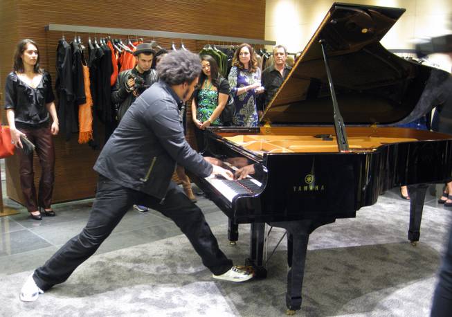 "Rockjazz" prodigy Eric Lewis plays the piano at the new Fendi store inside Crystals at CityCenter.
