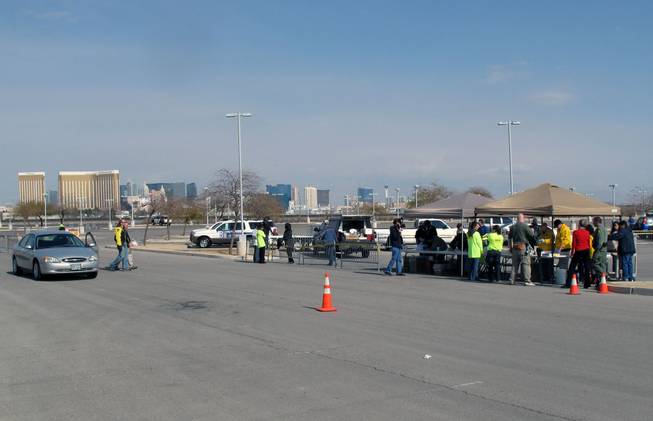 Metro Police officers and volunteers from the University of Southern Nevada collect unused prescription medications in a parking lot on Sunset Road on Saturday.