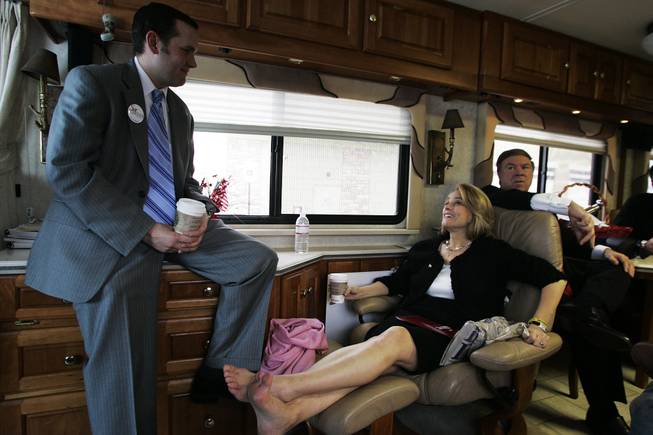 Campaign worker Nick Vander Poel (L) talks with Sue Lowden and husband Paul Lowden on Sue's campaign bus during a stop in Reno while making a campaign swing through northern Nevada Sunday, February 21, 2010.