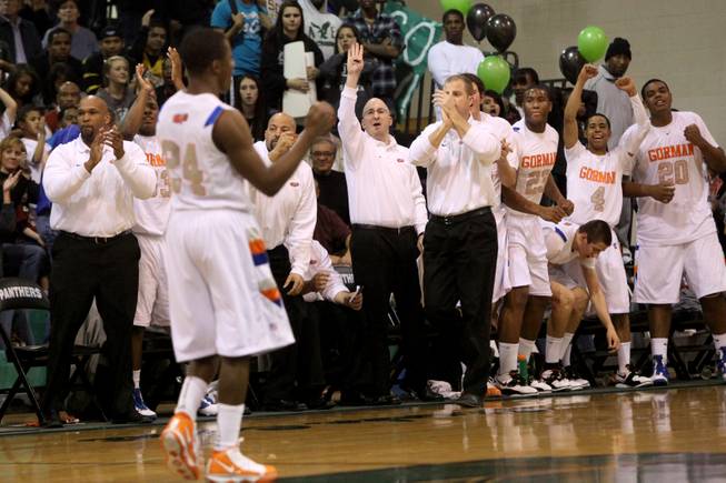 Bishop Gorman High senior guard Johnathan Loyd exits the Sunset Regional championship game in the final minutes to teammates cheering on the bench in the Gaels' 79-62 victory against host Palo Verde.