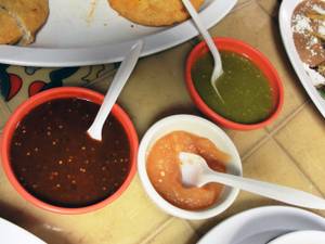 A trio of red chile, green chile and habanero salsas at Antojos DF.