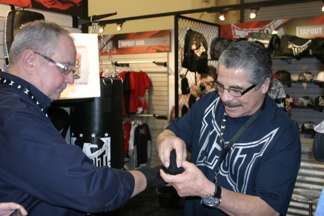 Jacob "Stitch" Duran demonstrates his wrapping skills at the TapouT booth at the MAGIC tradeshow. 
