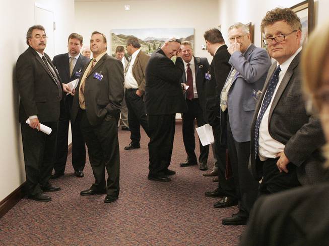 Lobbyists congregate in a hallway on Day 3 of the special legislative session Thursday, Feb. 25, 2010, in Carson City.