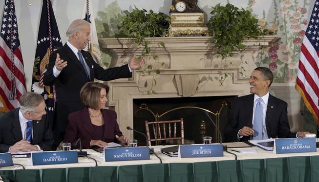 President Barack Obama smiles as he waits for Vice President Joe Biden to take his seat at the Blair House in Washington, Thursday, Feb. 25, 2010, during a meeting with Republican and Democratic Congressional leaders to renew efforts for health care reform. Seated, from left are Senate Majority Leader Harry Reid of Nev., and House Speaker Nancy Pelosi of Calif.