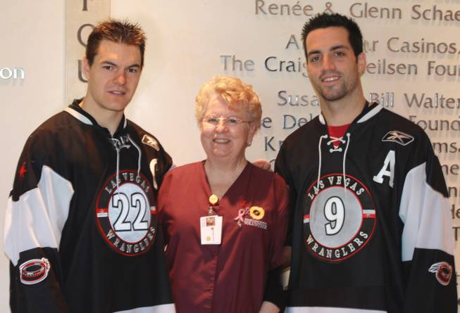 Las Vegas Wranglers Chris Neiszner and Mike Madill spend Thursday at the Nevada Cancer Institute.
