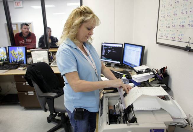 Tracy Giancola, an intake specialist with Las Vegas Justice Court, processes a bail transaction last week at the Clark County Detention Center. The court no longer allows inmates and bail bonds companies to post bail between midnight and 8 a.m. 