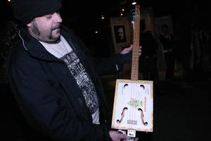 Super Fuzz and one of his custom cigar guitars.