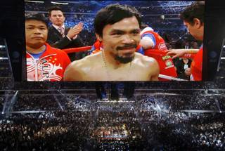 Manny Pacquiao, of the Philippines, is seen on a large video screen before his WBO boxing welterweight title fight against Joshua Clottey, from Ghana, in Cowboys Stadium in Arlington, Texas, on Saturday, March 13, 2010.