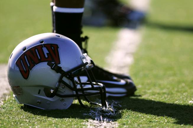 Players line up with their helmets during the first day of UNLV football practice Monday, March 15, 2010, at Rebel Park.