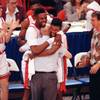 UNLV players Moses Scurry, left, and Anderson Hunt hug coach Jerry Tarkanian after their 103-73 victory over Duke in the NCAA Final Four Championship game, April 2, 1990, in Denver.