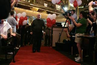 UNLV basketball coach Jerry Tarkanian enters on a red carpet Wednesday during an event to proclaim 