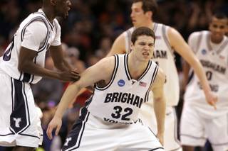 BYU guard Jimmer Fredette grimaces after shooting a three-point basket against Florida during the second overtime of their first round NCAA Basketball Tournament game Thursday, March 18, 2010 at the Ford Center in Oklahoma Ctiy. On the back of Fredette's 37 points, BYU posted its first NCAA tournament win since 1993 by beating Florida 99-92 in double overtime.
