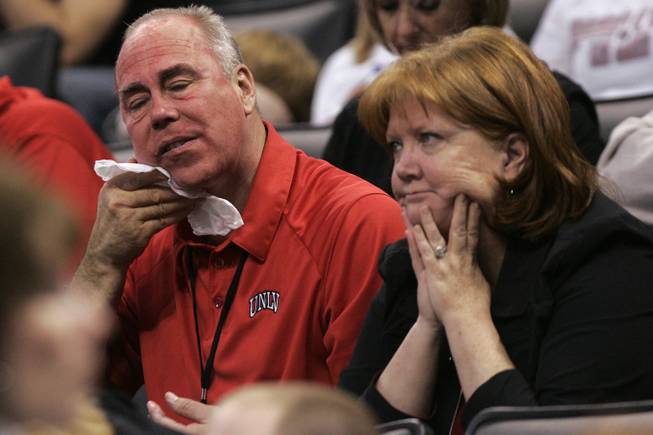 UNLV President Neal Smatresk, sitting with his wife, Deborah, wipes off his red face paint in the final minutes of Thursday's first-round NCAA Tournament game against UNI at the Ford Center in Oklahoma City. UNI won the game 69-66 on a last-second 3-point shot.