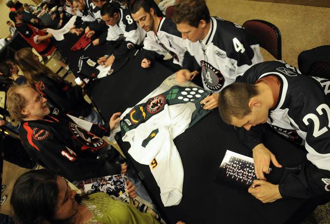 Wranglers players autograph memorabilia during Fan Appreciation Night at the Orleans Arena on Saturday, April 3, 2010.