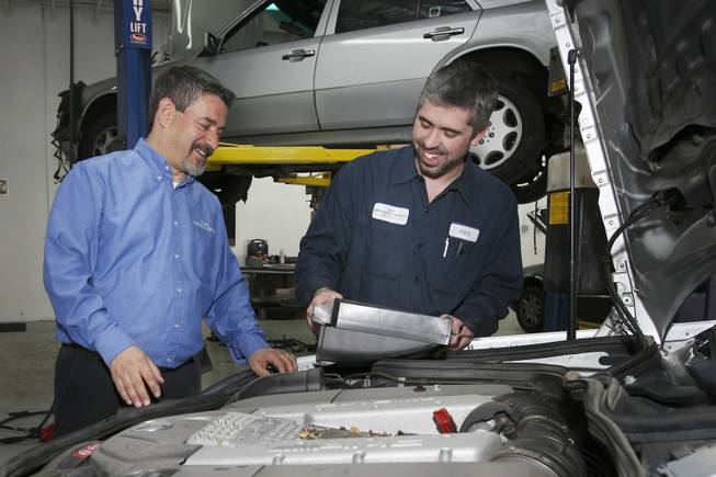 Owner Frank Scandura laughs with shop foreman Paul Shepherd, right, while inspecting a 2004 Mercedes-Benz at the Henderson location of Frank's Mercedes Service.