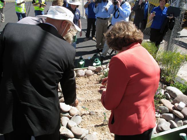 RTC General Manager Jacob Snow, left, and Rep. Shelley Berkley plant wildflower seeds Thursday to mark the start of construction on the new ACE Green Line.