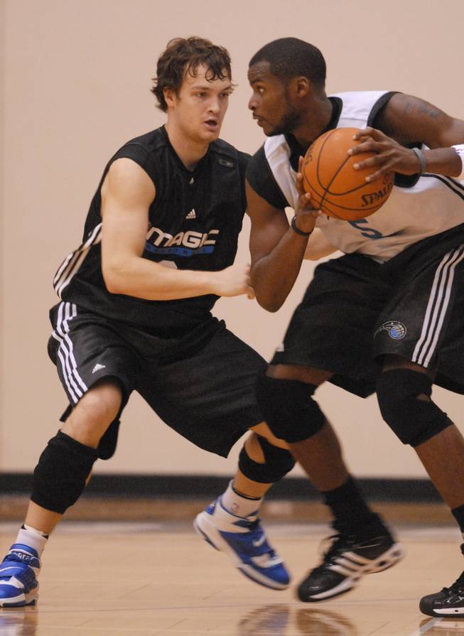 Orlando Magic guard Kevin Kruger, left, defends teammate Keyon Dooling on the first day of the team's training camp in Maitland, Fla., on Sept. 29, 2007.