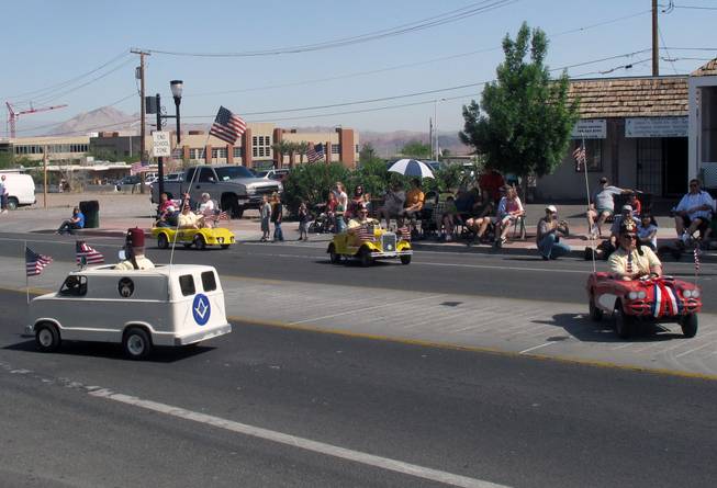 Members of the Zelzah Shrine Temple ride miniature cars in circles on the parade route Saturday during the Henderson Heritage Parade.