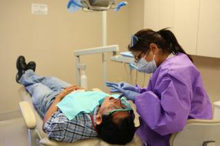Jairo Alvarez relaxes while being prepped for a crown by dental assistant Angie Bateman on Tuesday at the Nevada Health Center at 2212 S. Eastern Ave.