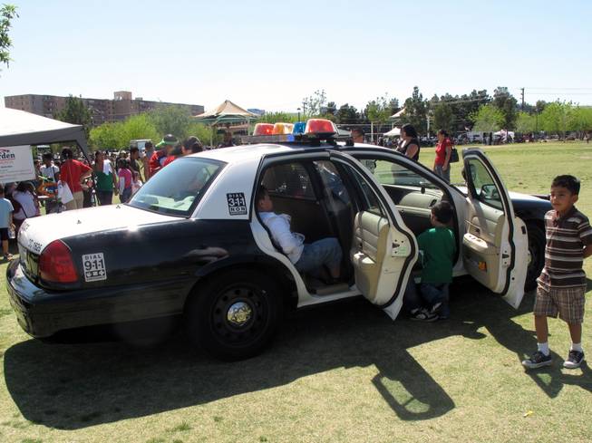 Kids get to explore a police car during the Children's Festival at Molasky Park, which was put on by Metro Police.