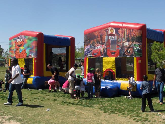 Kids line up to use the jump houses at the Children's Fesitval on Saturday.