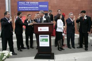 American and Chinese businessmen and dignitaries toast each other Tuesday at a ribbon-cutting ceremony announcing the launch of the final development phase of a wind turbine plant project involving A-Power Energy Generation Systems, Cielo Wind Services and the Greenspun Corporation.