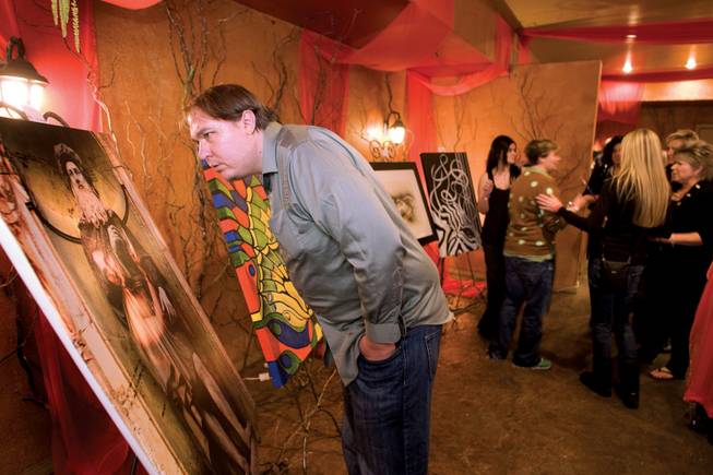 Nathan Harvey looks over "Port of DaVinci" by artist Max Lightbender during the ARTrageous Vegas 7th Annual Art Show at the Aruba.