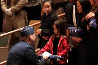Savonya Deutch, daughter of slain Nye County Deputy Ian Michael Deutch, receives an American flag during her father's funeral Saturday, May 1, at Canyon Ridge Church in Las Vegas.