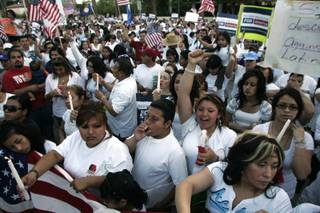 Participants cheer at a rally for immigration reform outside the Lloyd George Federal Courthouse on May 1.