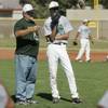 Rancho High School baseball head coach Tom Pletsch talks to pitcher Zak Qualls during practice Tuesday, May 18, 2010.