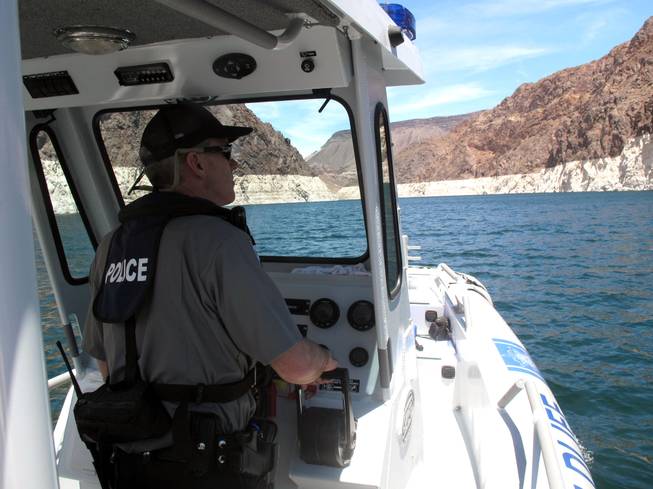 Nevada game warden Lt. Mike Maynard patrols Lake Mead Thursday.