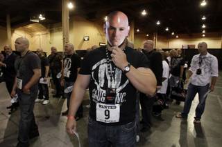 Bob McClearen, 25, of Chicago holds up an UFC President Dana White mask as he waits with others for a Dana White look-a-like contest during the UFC Expo at the Mandalay Bay Convention Center May 28, 2010.