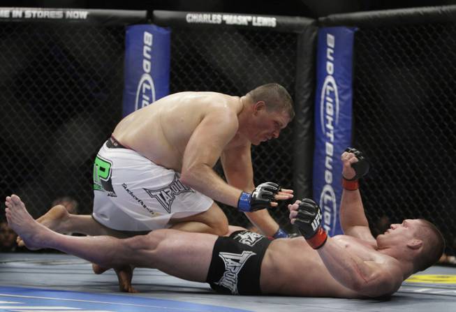 Mike Russow, left, of Illinois jumps onto Todd Duffee of Las Vegas after knocking him down in the third round of their heavyweight fight during UFC 114 on Saturday at the MGM Grand Garden Arena.