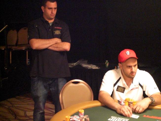 Robert Mizrachi, left, watches on as his brother Michael "The Grinder" Mizrachi, right, plays a hand in the $50,000 Poker Player's Championship Monday at the Rio. The brothers will play together for a shot at $1.56 million and a gold bracelet tonight at the final table. 