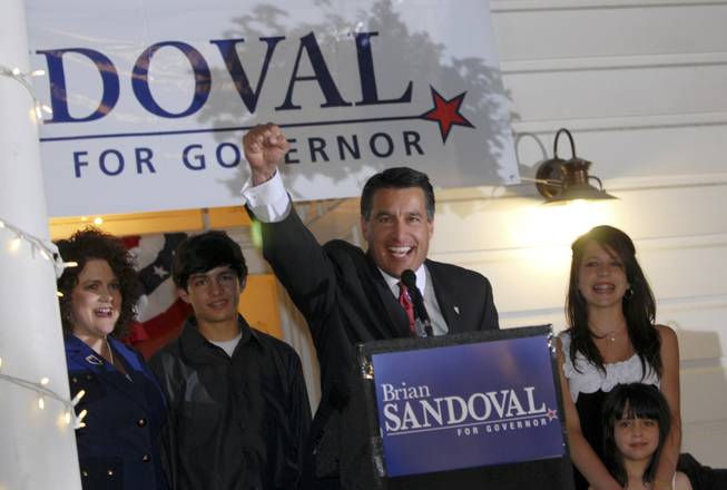 Former federal judge and gubernatorial candidate Brian Sandoval celebrates his victory over incumbent Gov. Jim Gibbons in the party primary at the Garden Shop Nursery in Reno on Tuesday, June, 8, 2010. Standing by during his acceptance speech is his wife, Kathleen, and children, James, Maddie, and Marisa.