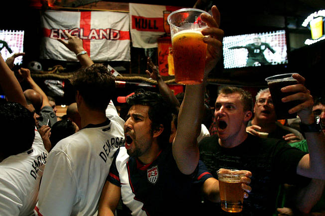 Ricardo Fino raises his glass of beer during a penalty kick while watching the USA vs. England World Cup match Saturday, June 12, 2010 at the Crown and Anchor. In their first World Cup meeting since the US scored a historic upset in 1950, the two rivals tied 1-1.