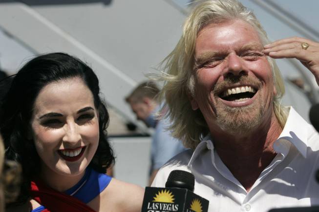 Virgin Airlines President Richard Branson and burlesque star Dita Von Teese speak to reporters during a media event to mark the 10th anniversary of Virgin Atlantic's London to Las Vegas route Tuesday, June 15, 2010.