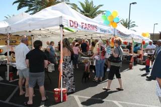 Patrons look for items during the farmers and artisans market Sunday in Henderson. 