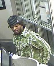 Surveillance video image of a man wanted in connection with the bank robbery. 
