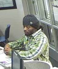 Surveillance video image of a man wanted in connection with the bank robbery. 