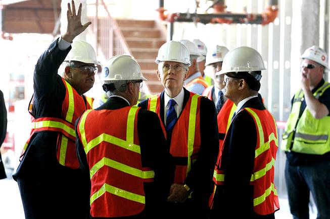 Veterans Affairs Network Director Ron Norby (L) speaks to Senator Harry Reid and  Veterans Affairs Secretary Eric Shinseki (R) as they tour the VA hospital that is under construction in Las Vegas Tuesday, July 6, 2010. The hospital, serving strictly veterans, is slated to open in 2012.