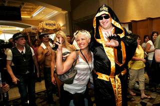 Phil Helmuth poses for a photo with a fan as he makes his grand entrance on the third day of the opening round of the World Series of Poker Main Event on Wednesday at the Rio.